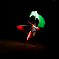 A vibrant multiple exposure of a dancer mid-spin, blending with colorful light trails.