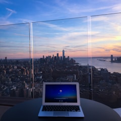Cloud solutions dashboard displayed on a laptop with UK city skyline in background.