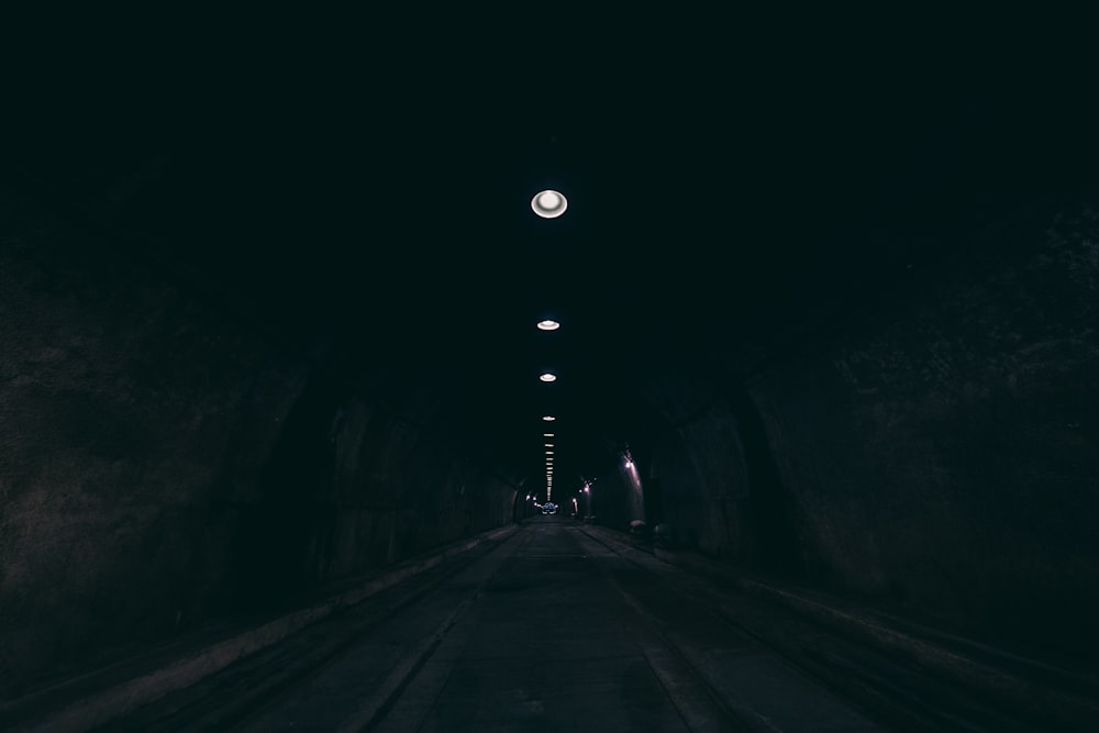 person walking on tunnel during nighttime