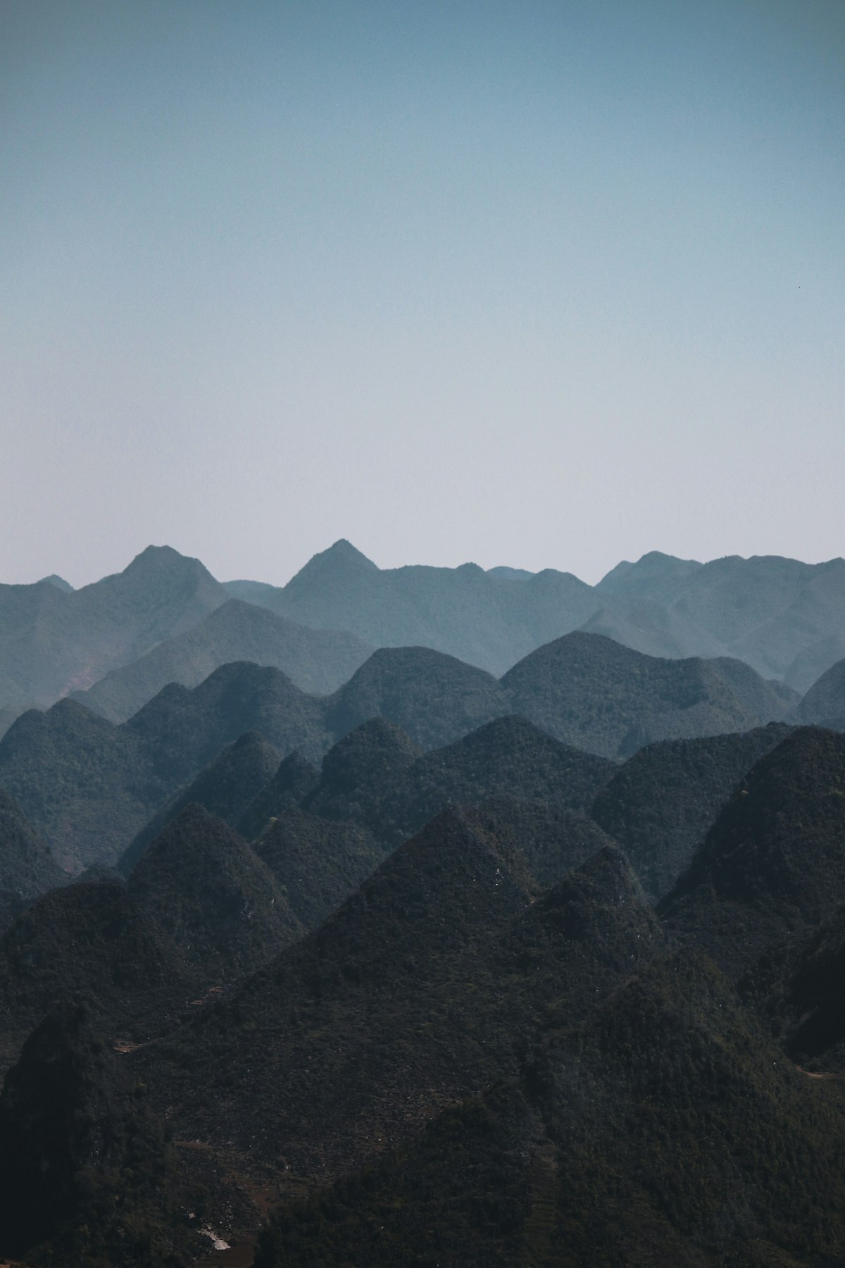 Beyond Yên Minh the land turns to stone — jagged grey karst peaks of the Đồng Văn Plateau stack toward the horizon near Lũng Táo, a UNESCO Global Geopark landscape unlike anywhere else in Vietnam.