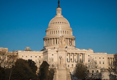 white concrete building under blue sky during daytime capital building google meet background