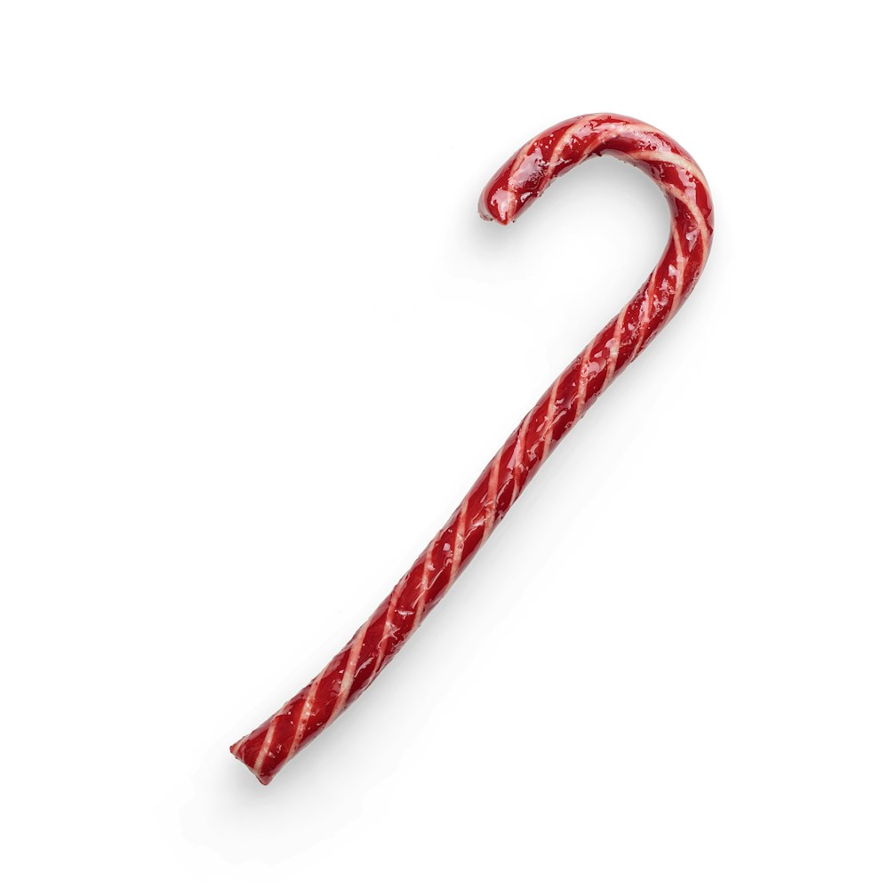 red candy cane on white background