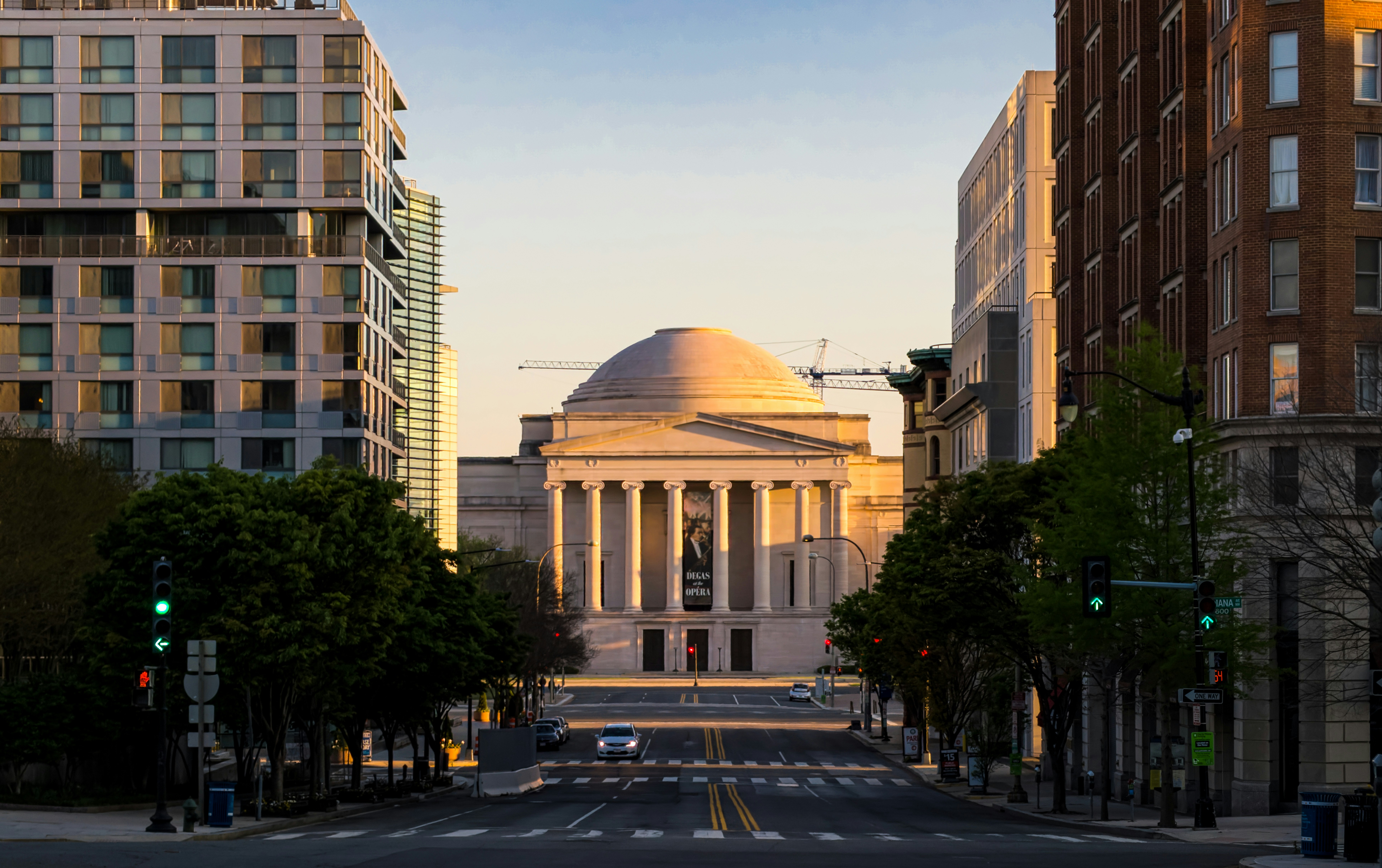 beige concrete building during daytime, Washington DC streets at sunset are nearly deserted during the Coronavirus epidemic. 