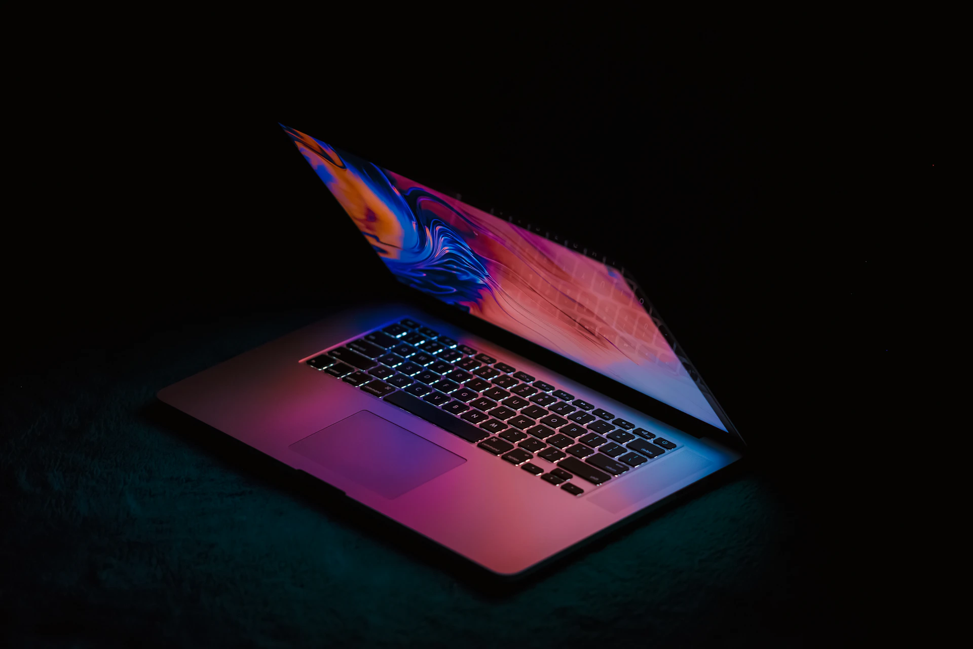 macbook pro on black textile