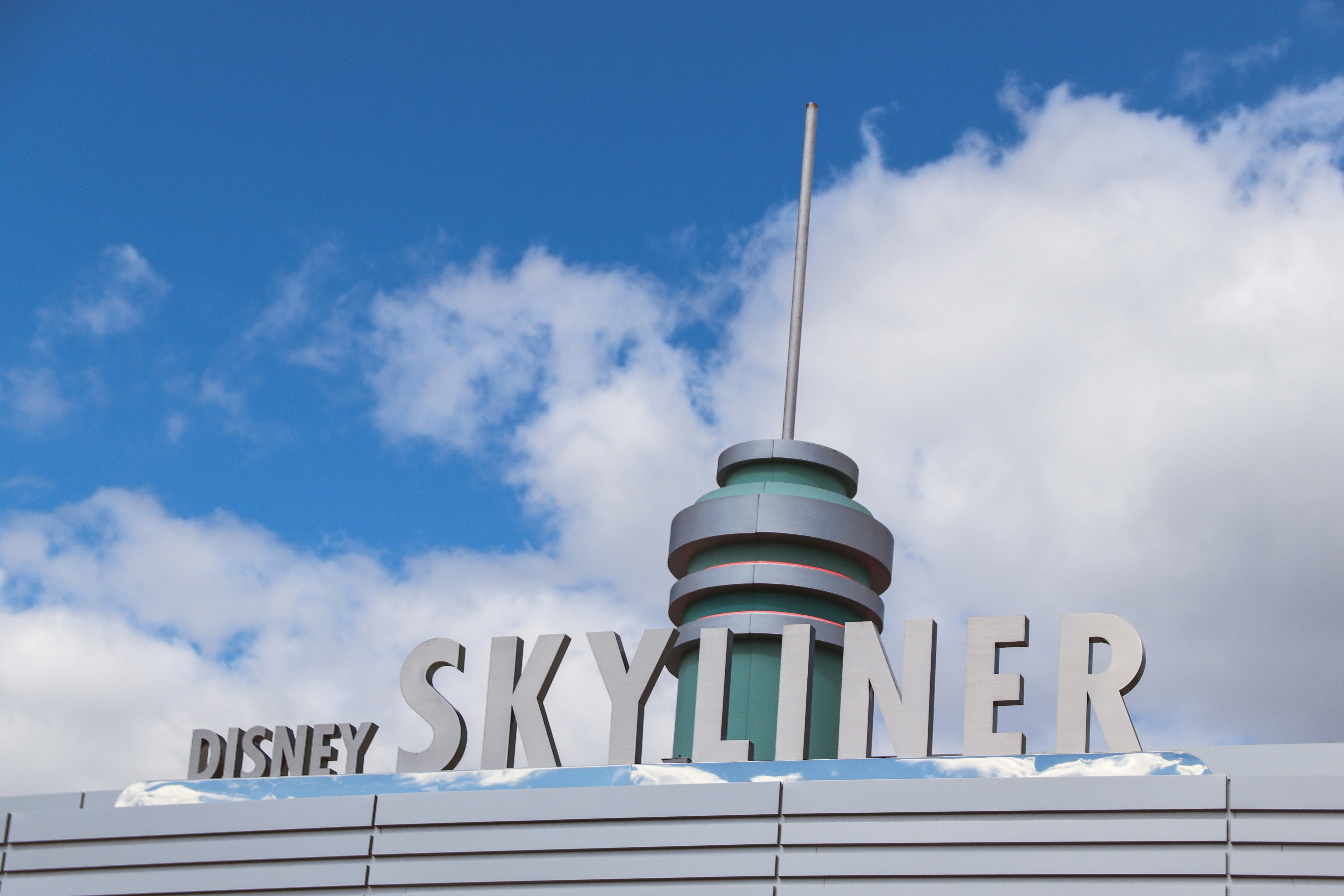 a sign that says disney skyliner on top of a building