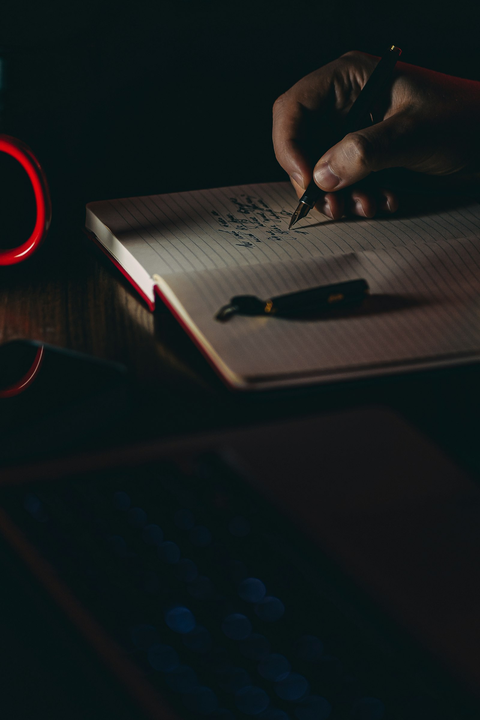 A hand writing notes on paper, generating content ideas