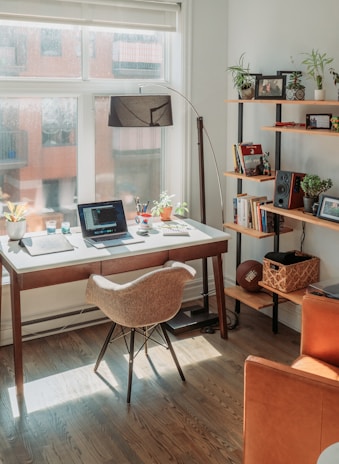 black laptop computer on brown wooden table