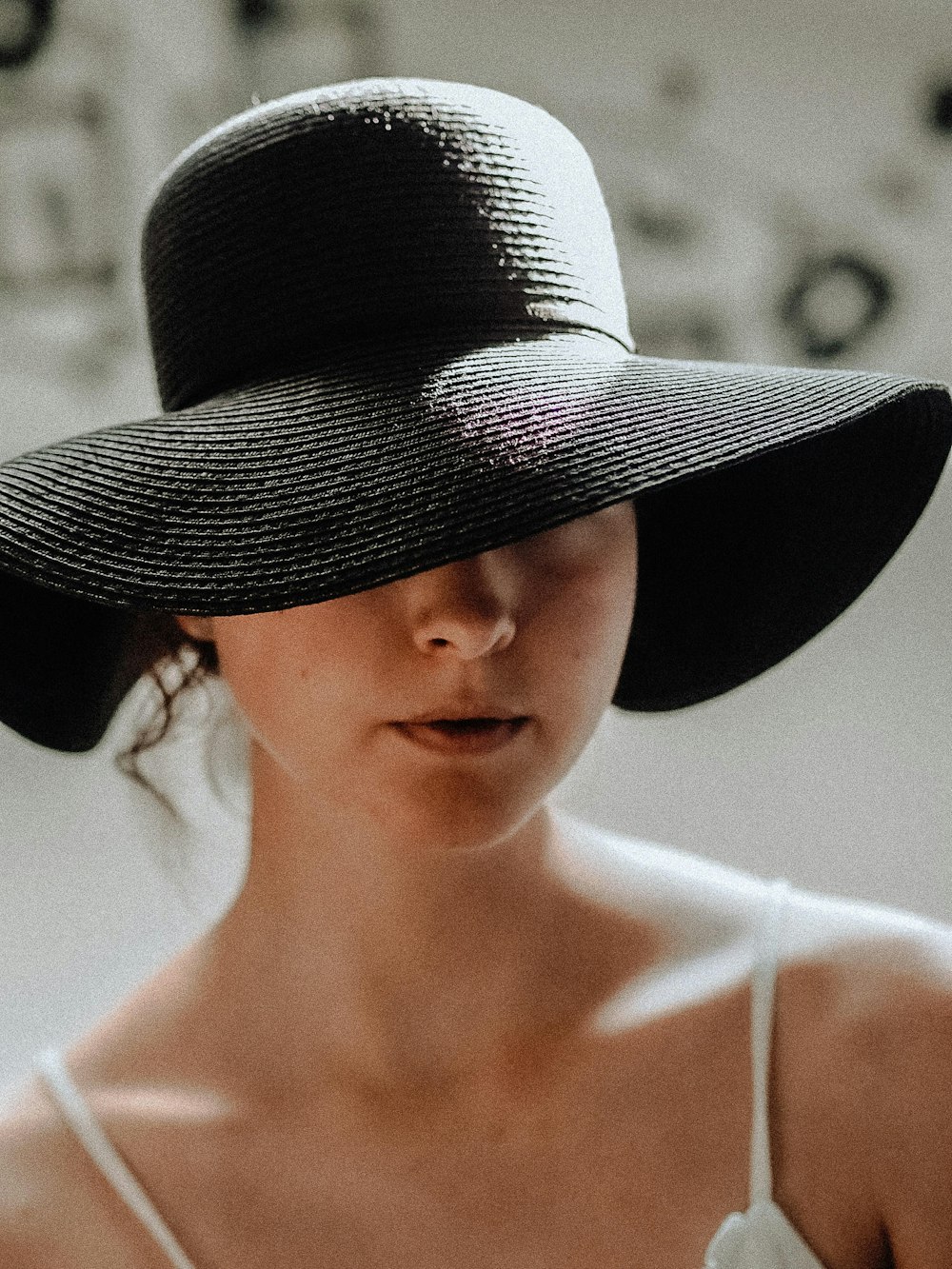 woman wearing black and white fedora hat