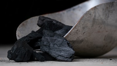 black stones on white sand coal teams background