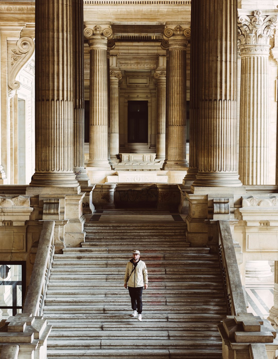 woman in white long sleeve shirt and black skirt walking on brown concrete stairs