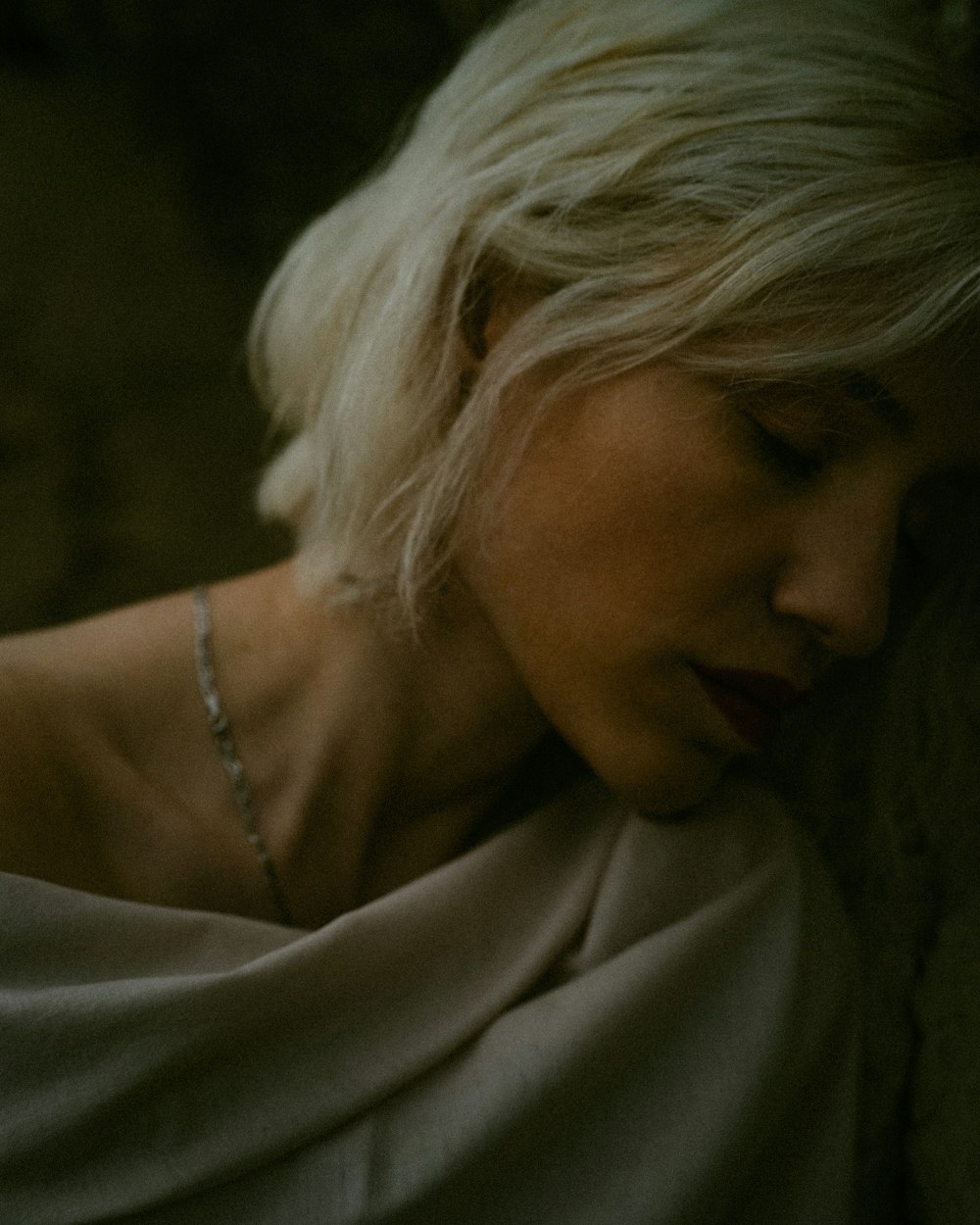 woman in white robe wearing silver necklace