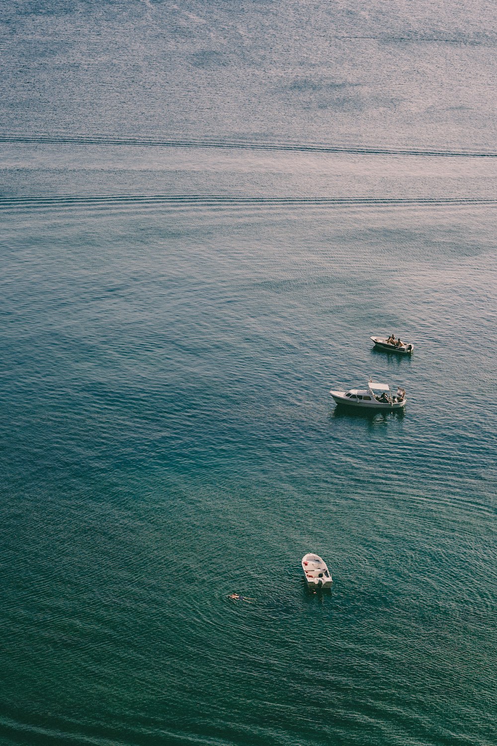 white boat on body of water during daytime