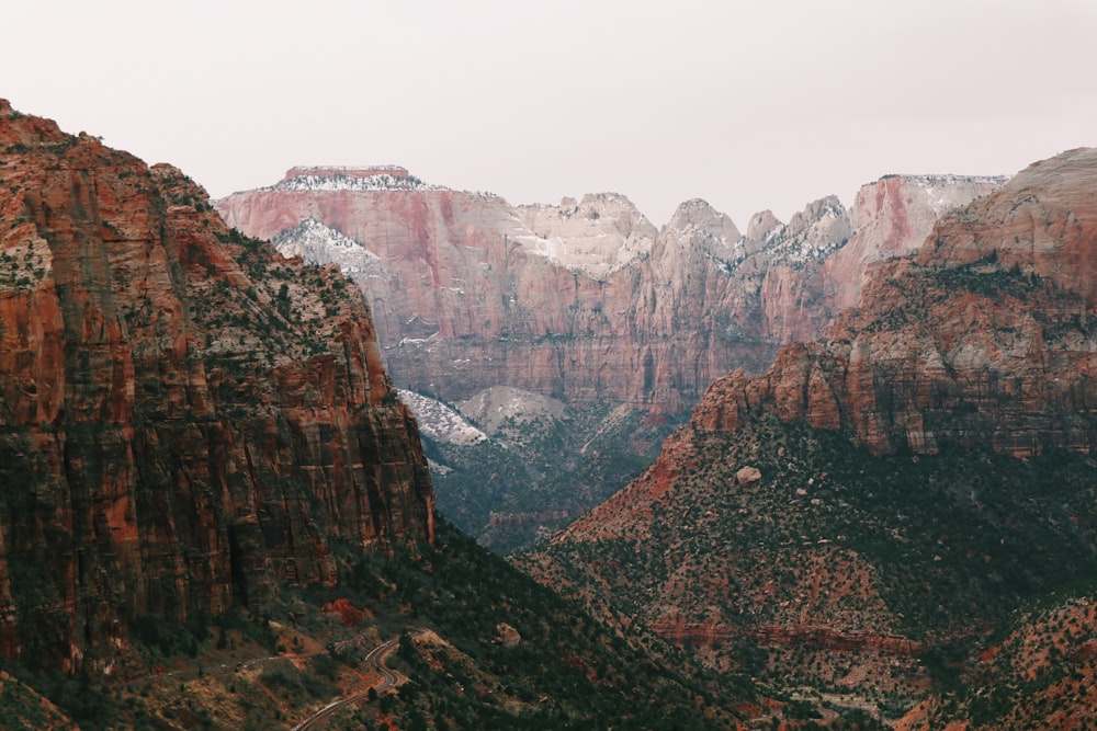 brown rocky mountains under white sky during daytime