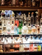 clear glass bottles on brown wooden shelf