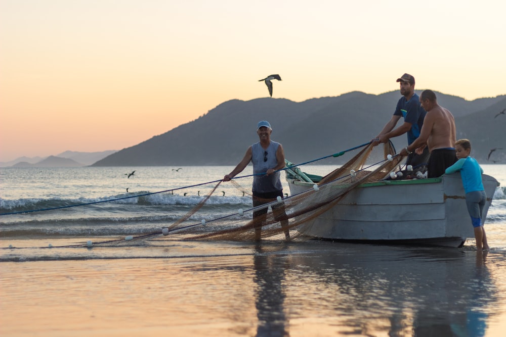 man in blue shorts standing on brown wooden boat during daytime