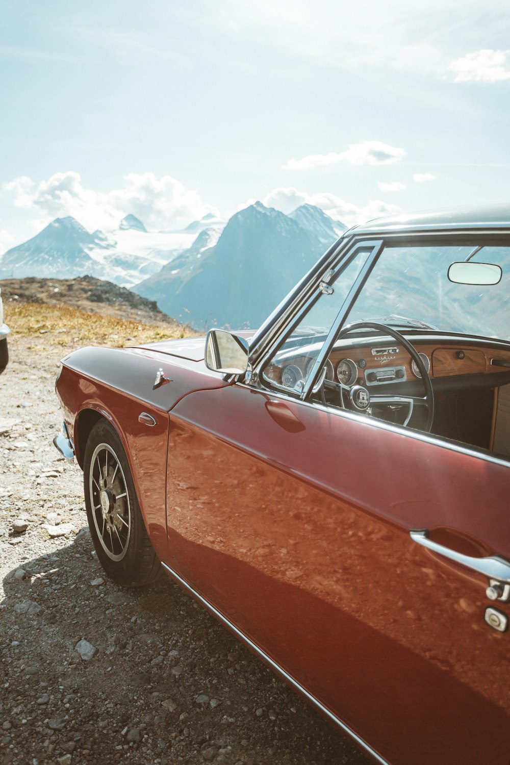 red car on gray rocky ground during daytime