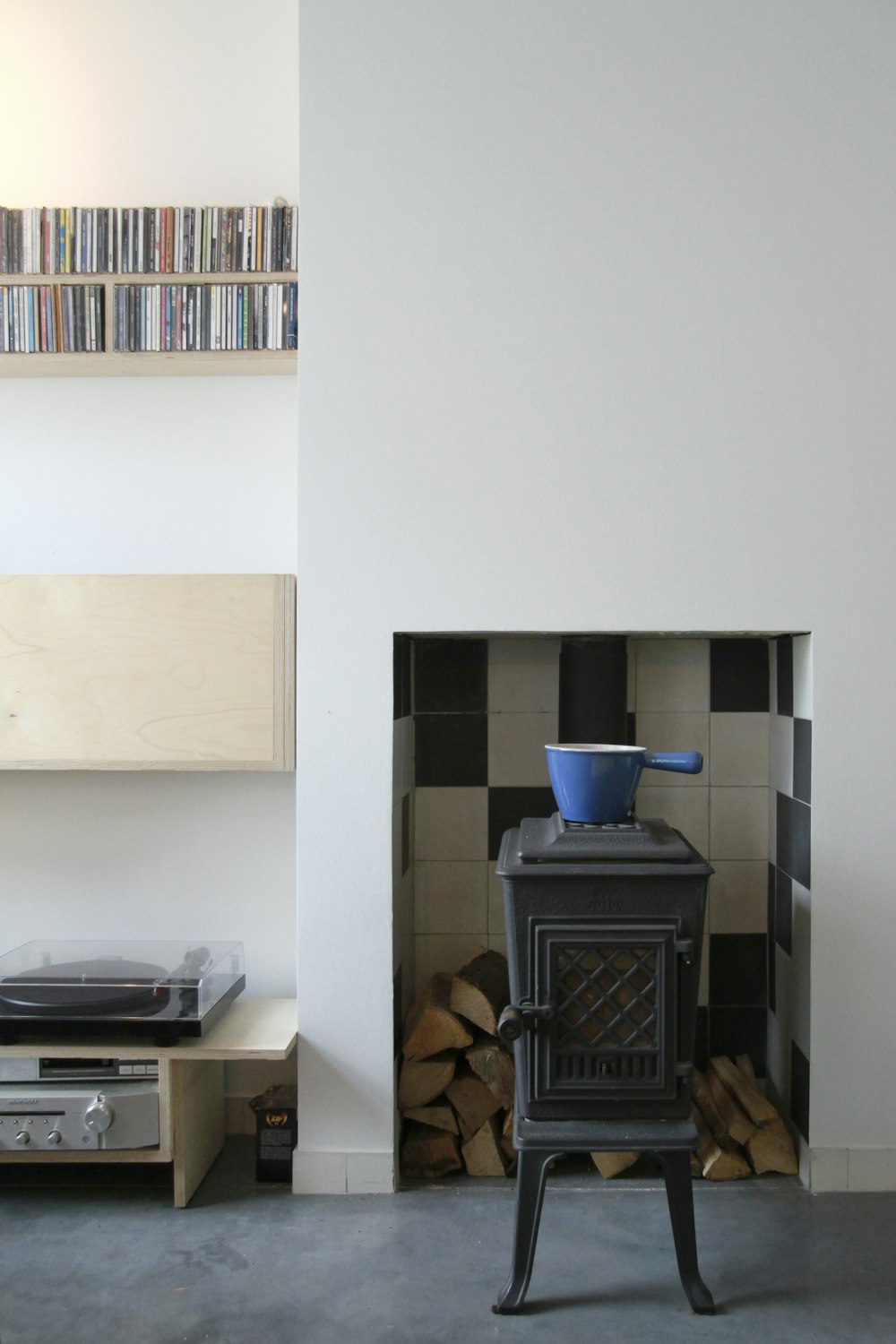 black wood burner beside white wall