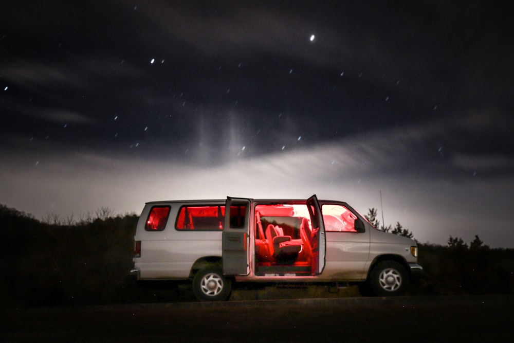 white and red van on road during night time