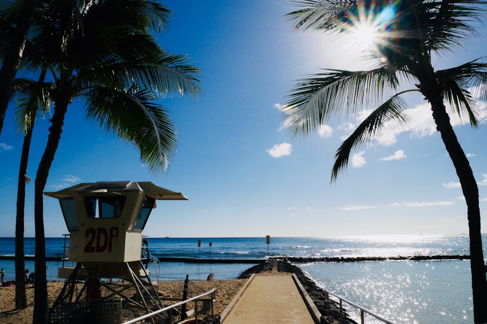 brown wooden beach house near sea during daytime