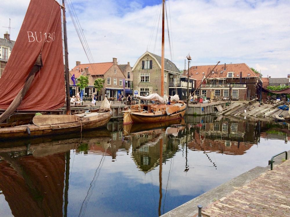 brown and white boat on dock during daytime