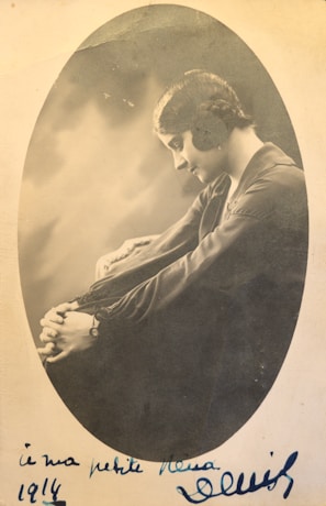 A sepia-toned photograph of a World War I nurse tending to wounded soldiers in a makeshift field hospital.