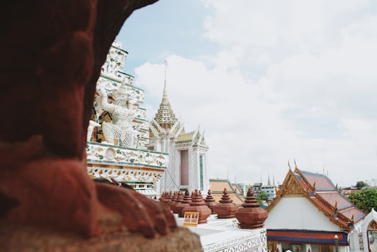 white and brown concrete building under white clouds during daytime in Wat Arun Ratchawararam Ratchawaramahawihan Thailand