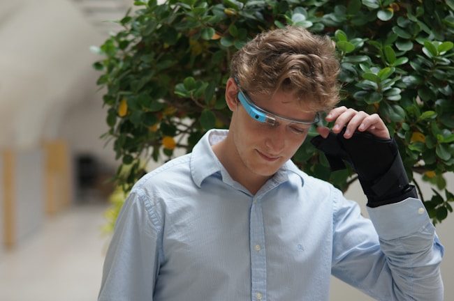 Smiling young woman trying on sleek black-rimmed glasses through AR virtual try-on.