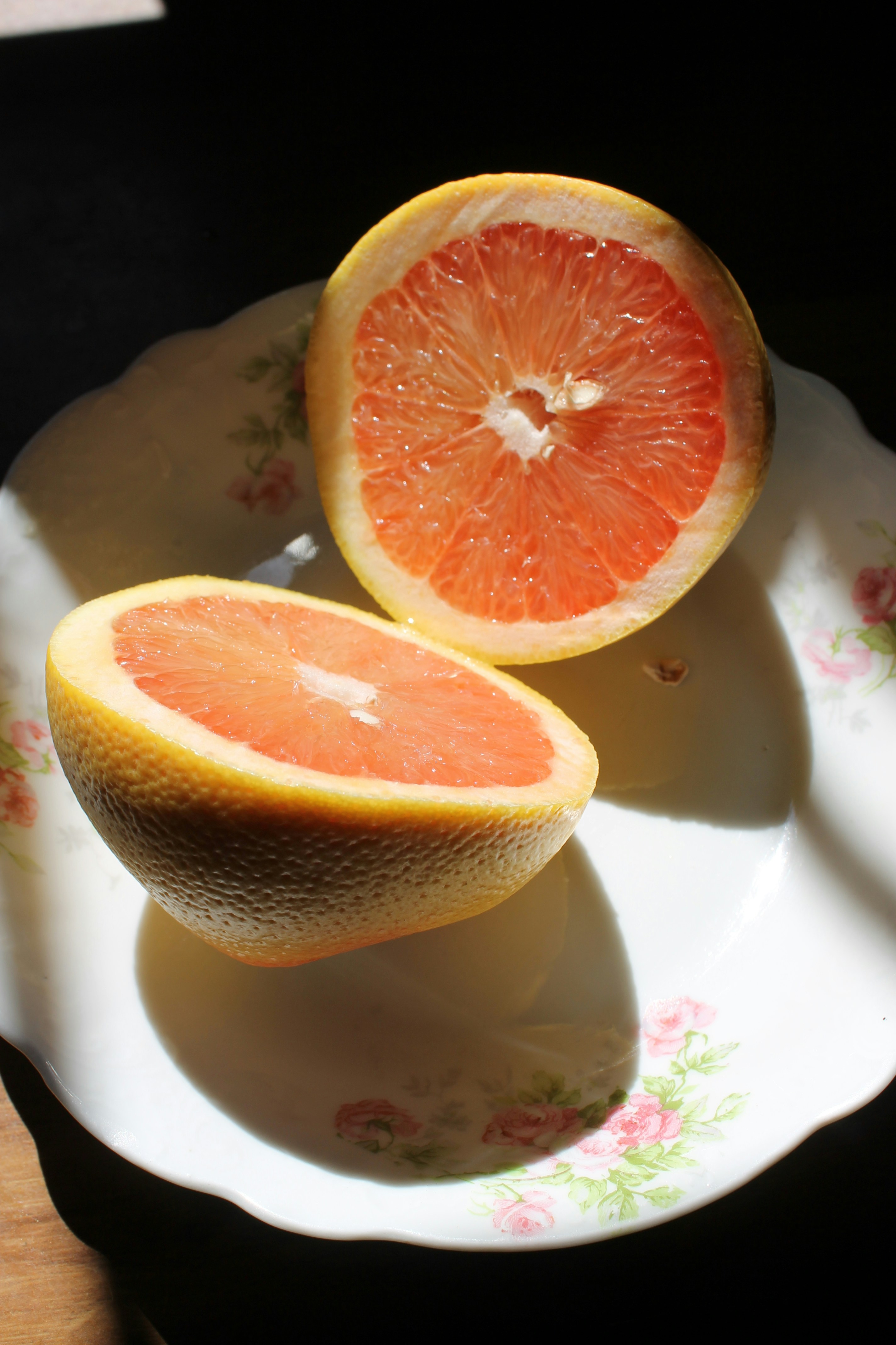 A vibrant, healthy plate with half a pink grapefruit and a perfectly hard-boiled egg