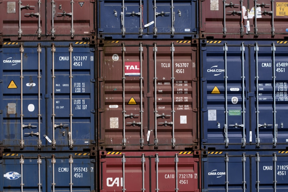 Red and black metal shipping containers stored outdoors — standard ISO shipping containers for rental and sale in Ottawa