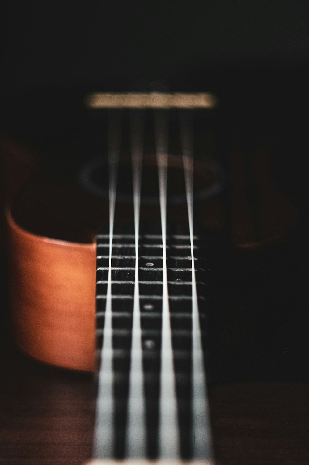 brown acoustic guitar in close up photography