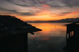 Serene sunset over the Taj Mahal with orange and pink hues reflecting on calm waters