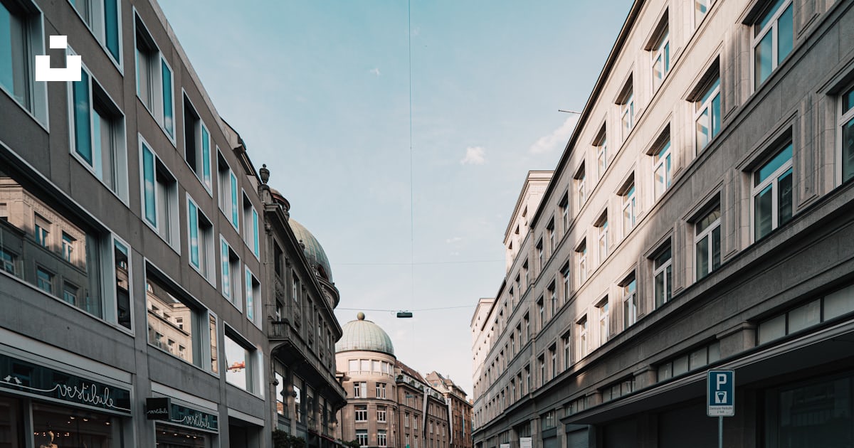 Empty road between high rise buildings during daytime photo – Free ...