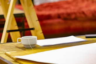 Close-up of a cup of tea next to a notepad with ‘askpaddy’ website open on a tablet screen.