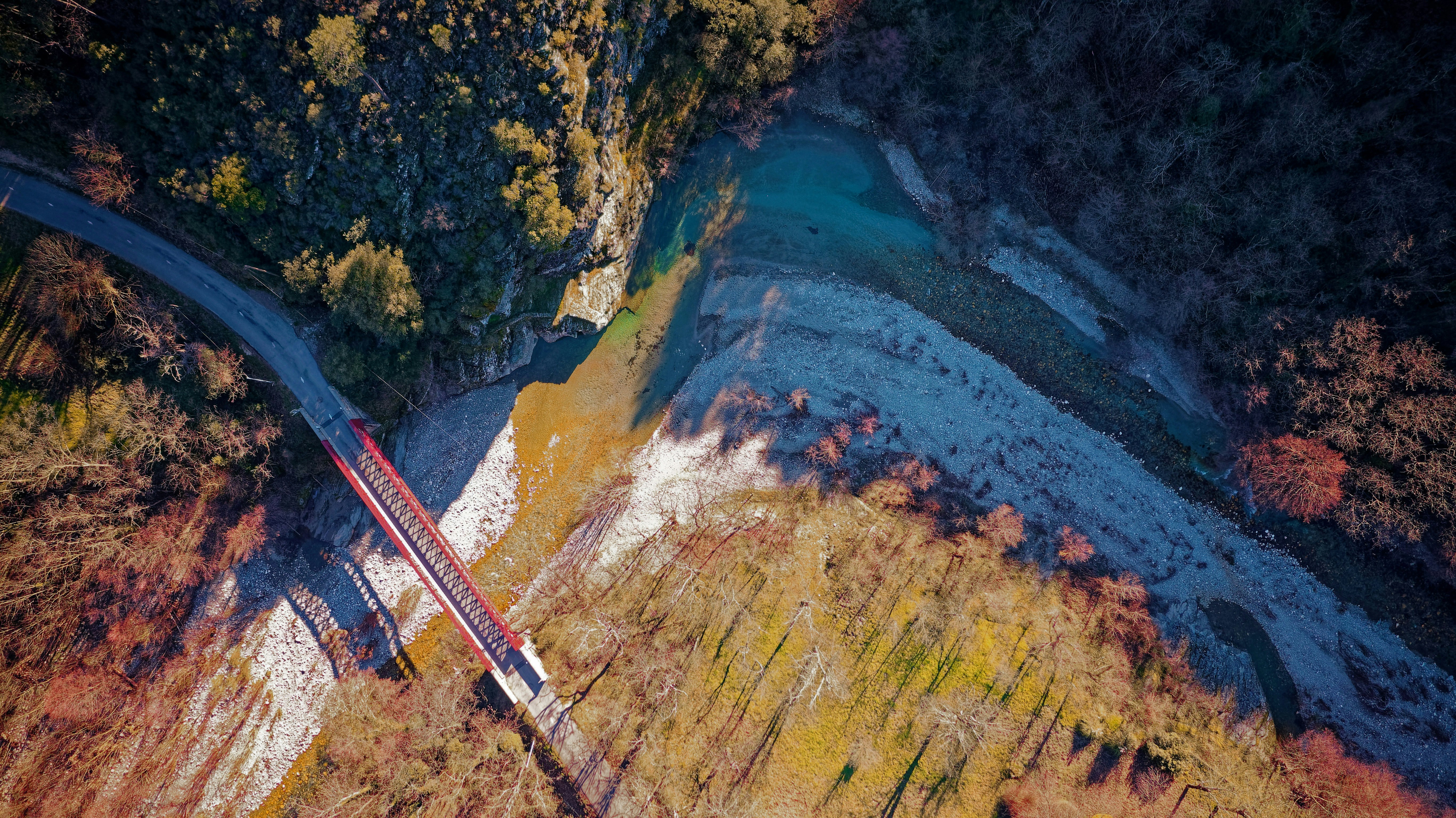 red and white metal tower on brown and green mountain