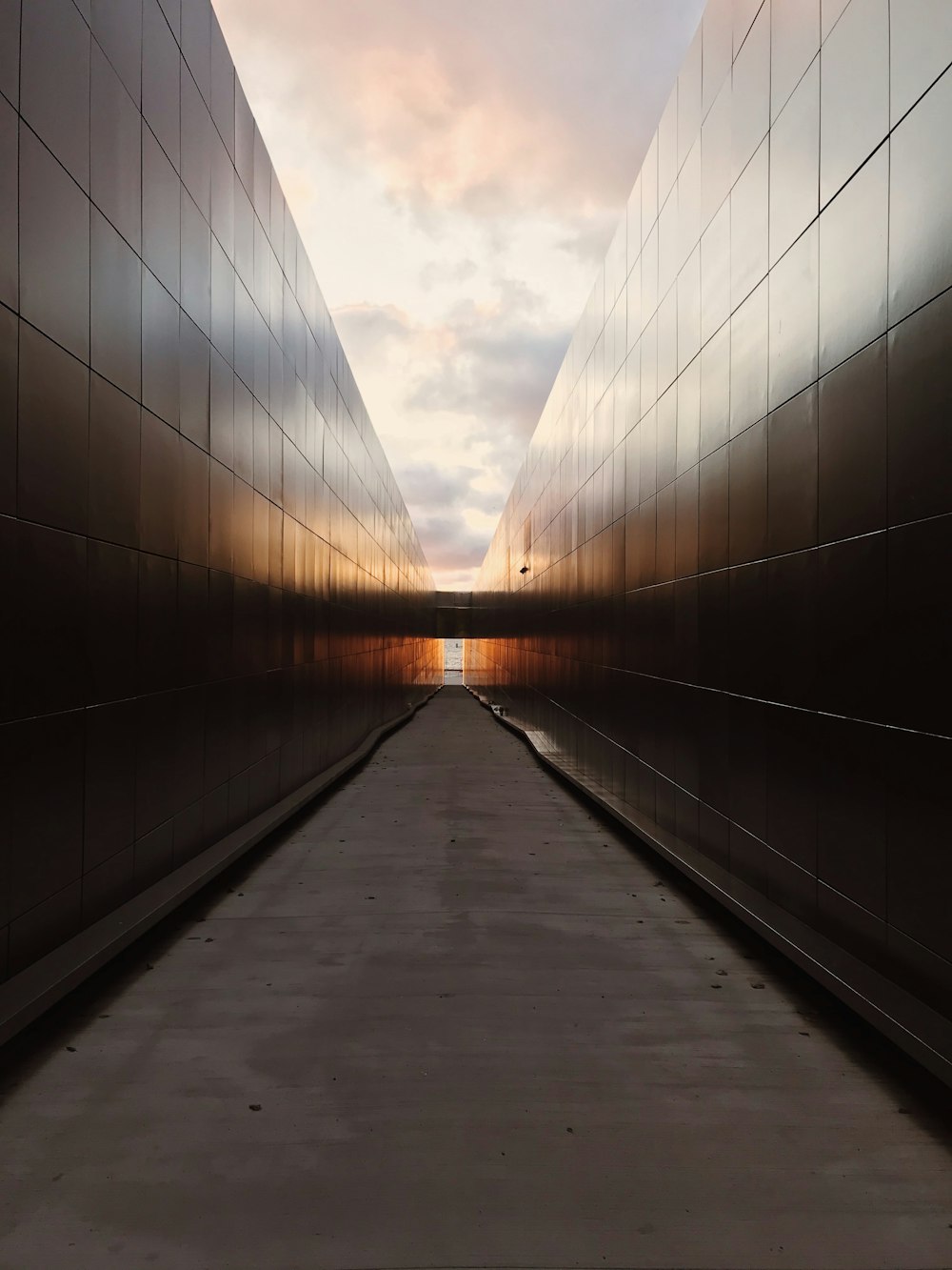 gray concrete bridge under cloudy sky during daytime