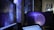 Several computer screens are displaying digital art and animations, including swirling galactic visuals and geometric designs. The atmosphere is futuristic and artistic, enhanced by ambient lighting. Various objects such as bottles and figurines appear in the background, creating an eclectic and creative environment.