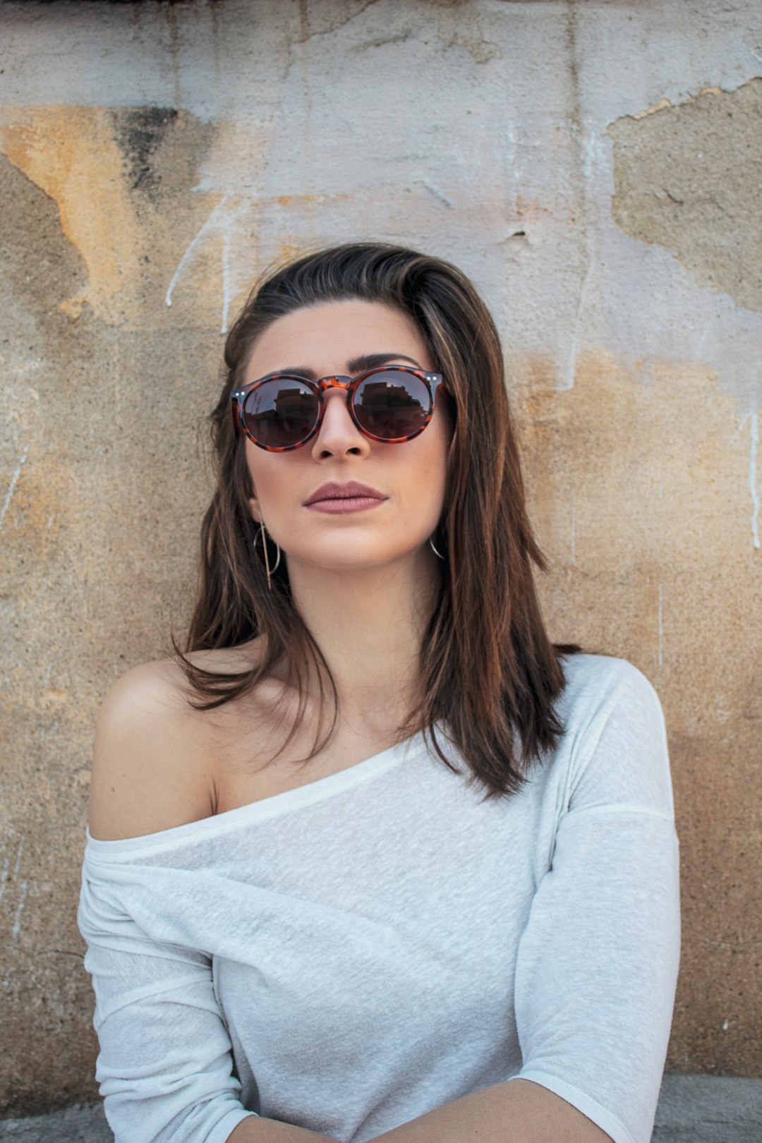 woman in white tank top wearing black sunglasses