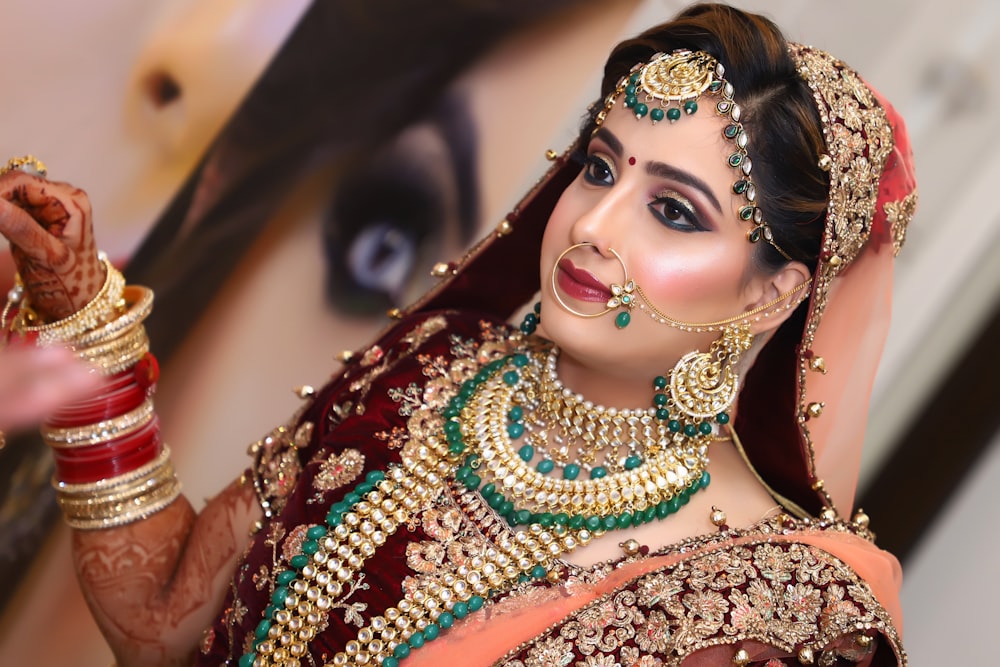 woman in red and gold sari