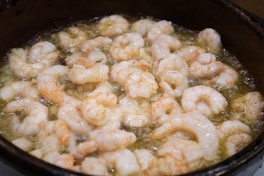 white and brown dish on black cooking pot
