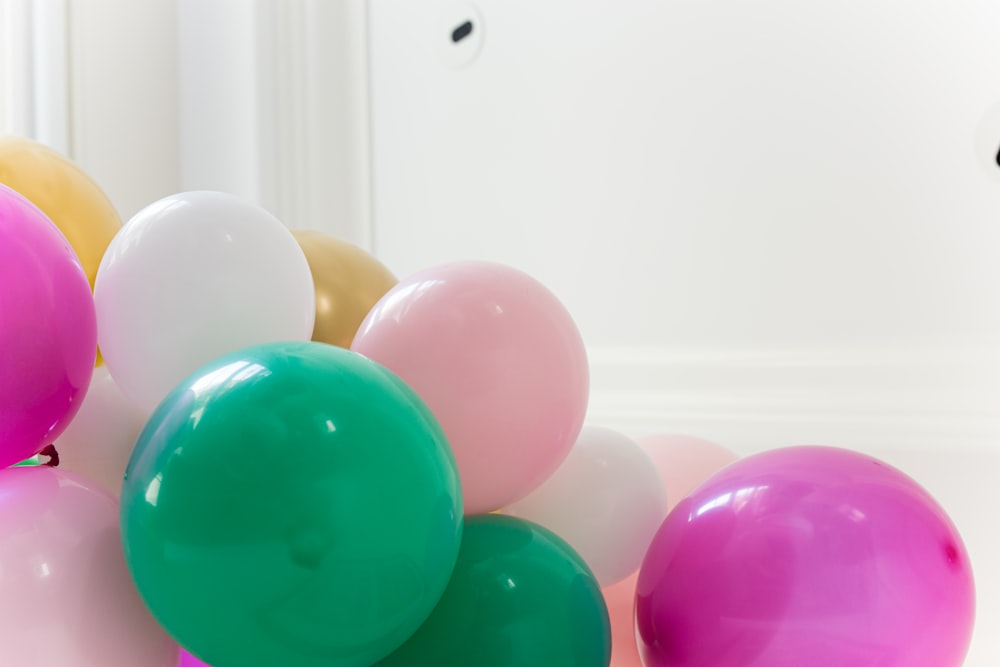 purple and pink balloons on white wall