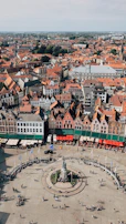 An aerial view of a bustling town square with cafes and shops, illustrating the neighborhood vibe.