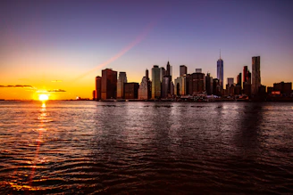 A stunning city skyline at sunset with a luxury hotel in the foreground.