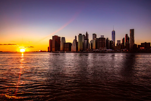 A stunning city skyline at sunset with a luxury hotel in the foreground.