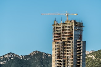 brown concrete building near mountain during daytime