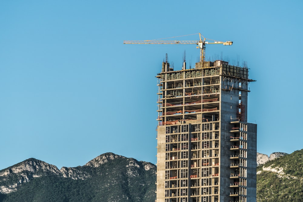 brown concrete building near mountain during daytime