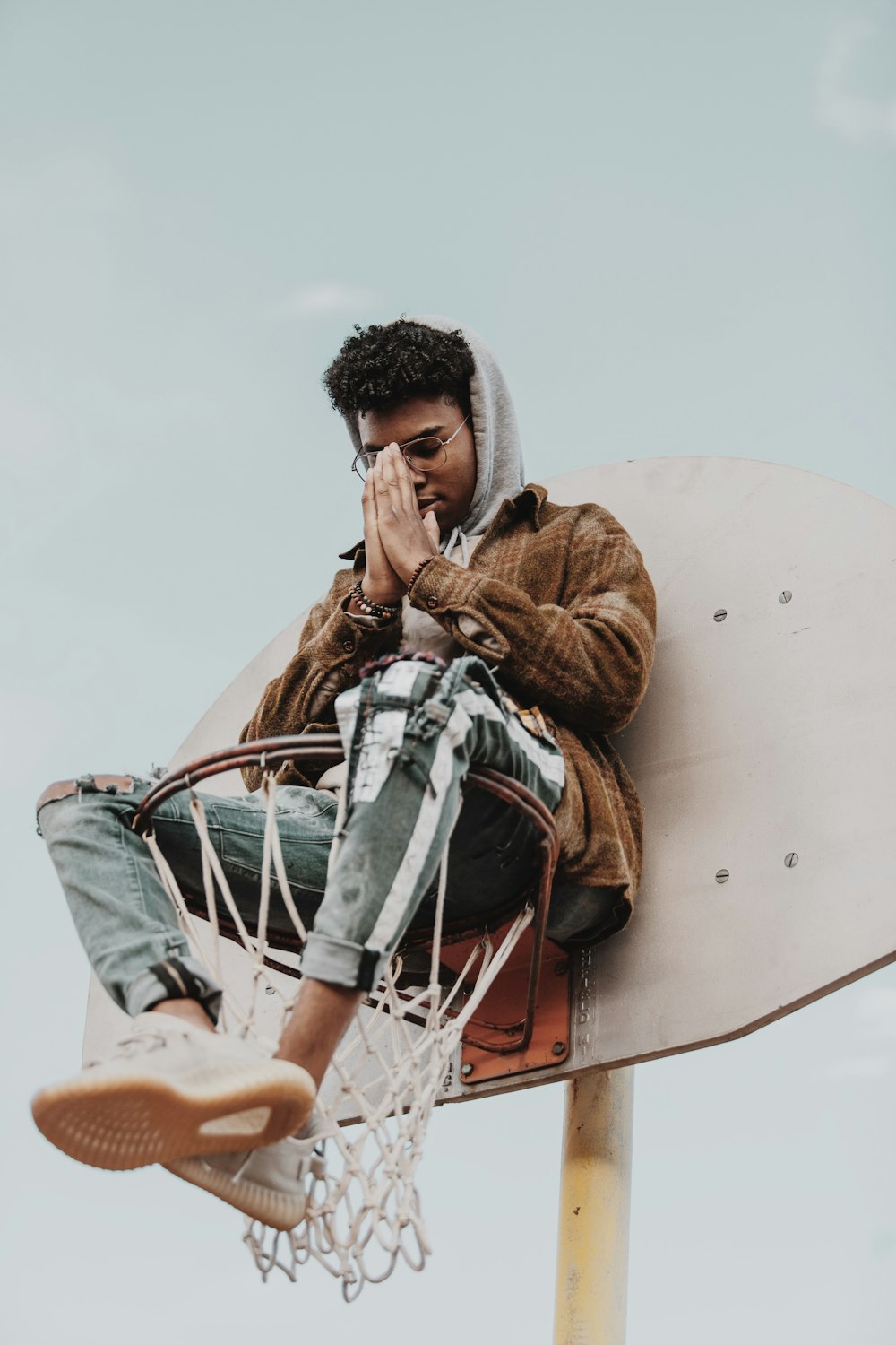 man in brown jacket and blue denim jeans sitting on white boat during daytime