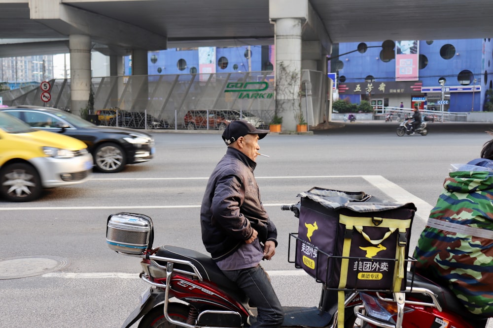 man in black jacket and black pants riding on motorcycle on road during daytime