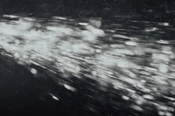 A creative video section with animated particles swirling around dramatic lighting.