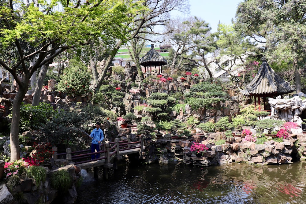 people sitting on wooden dock near body of water during daytime