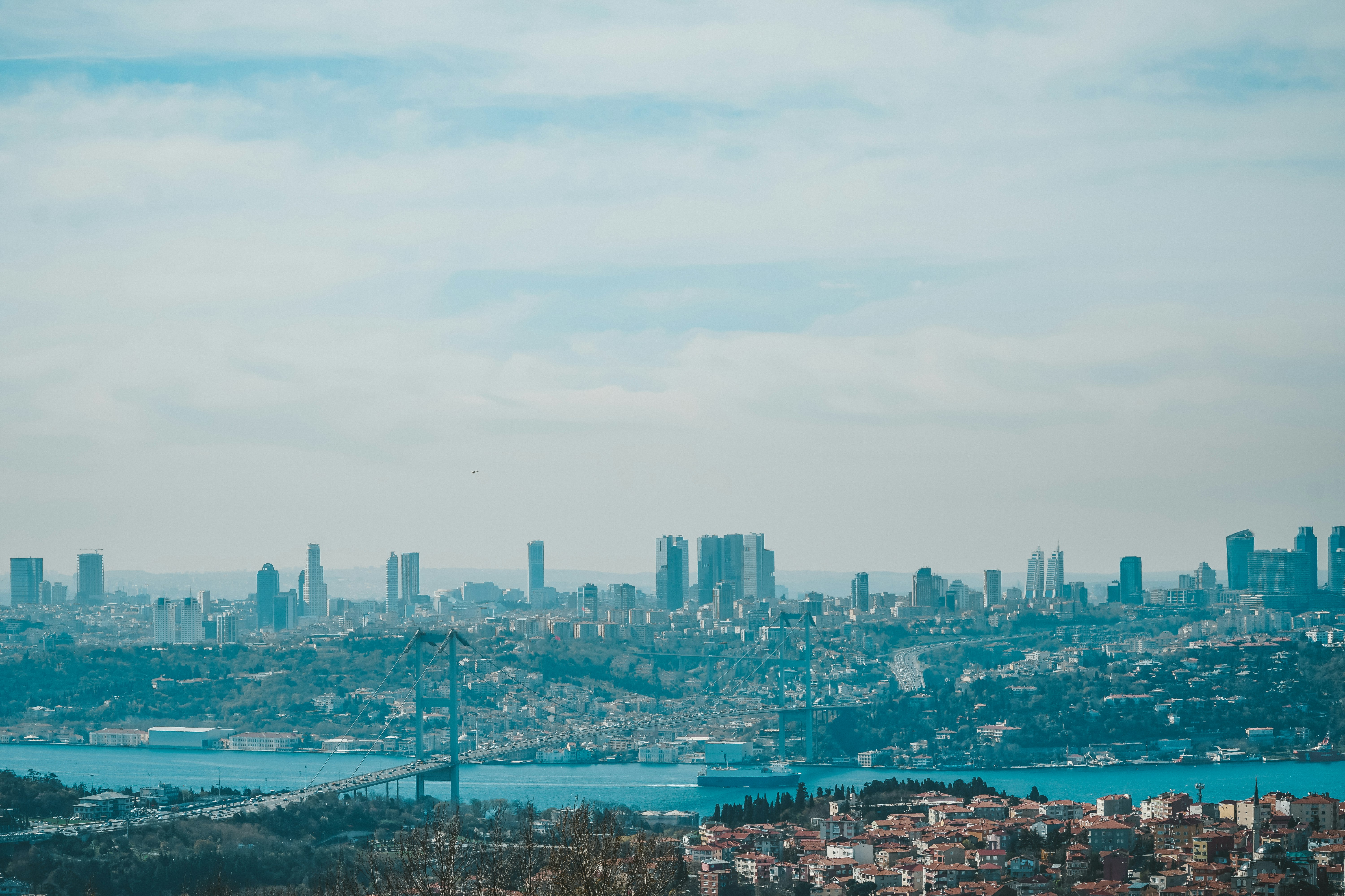 city skyline under white clouds during daytime